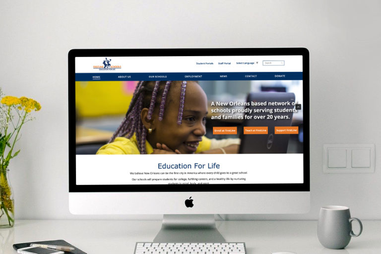 A computer displaying Firstline Schools website